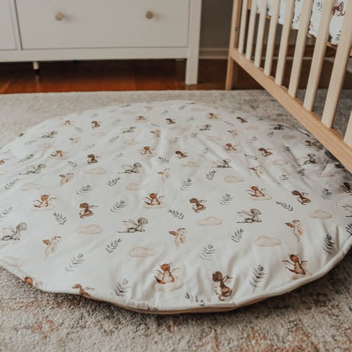 An image of snuggly jacks mystique dragon play mat laid out on the floor of a nursery