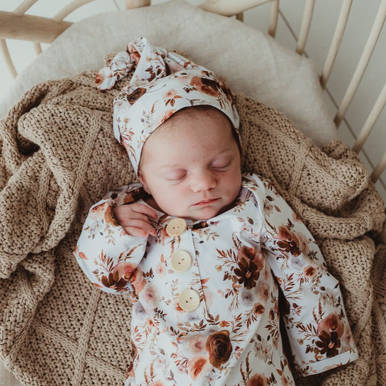 Cute infant sleeping in a bassinet on a cotton blanket 