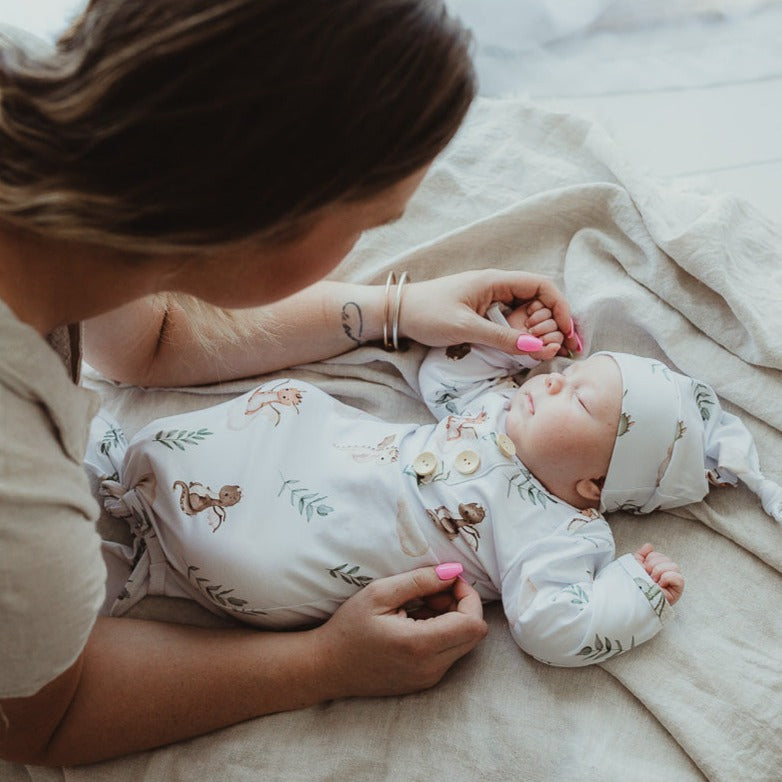 Mum look over her resting baby while he snuggles in for a rest