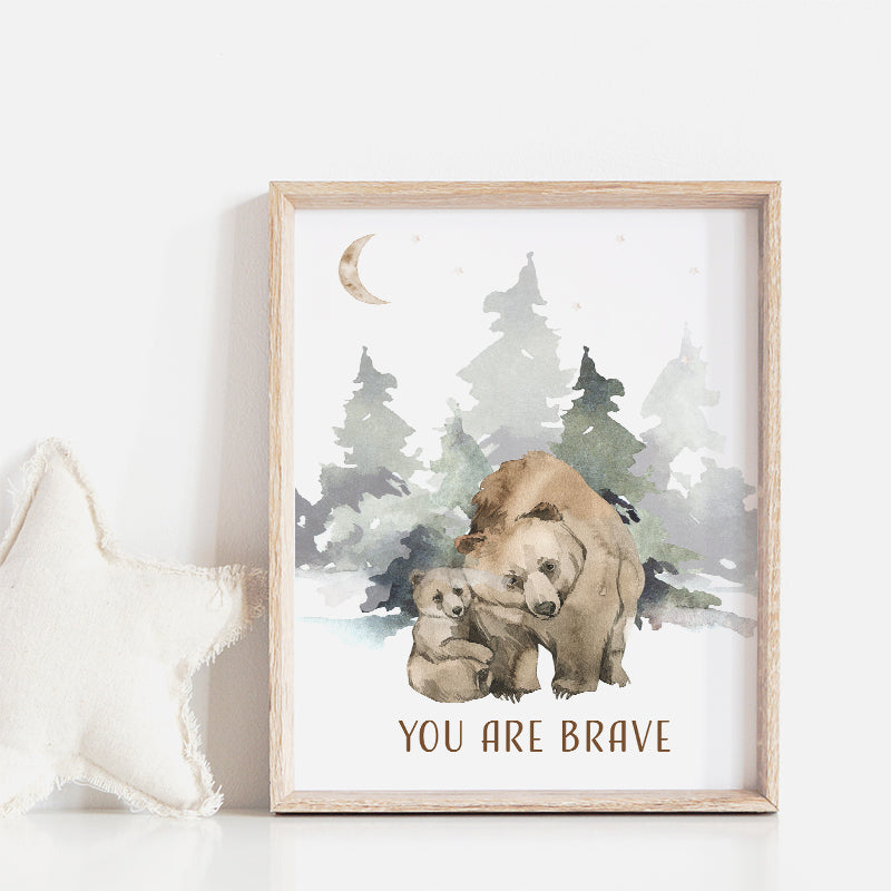 Picture of a brown bear and her cub walking in the forest, in a brown frame hanging on a nursery room wall